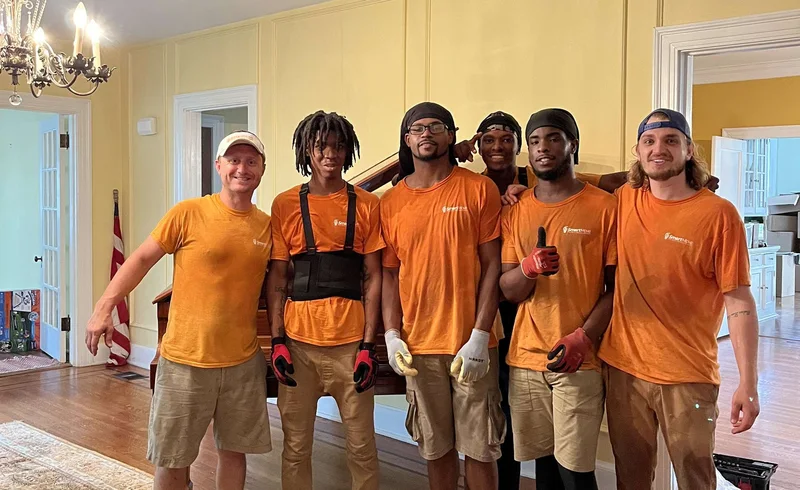 Five Smart Move crew members standing together on a porch