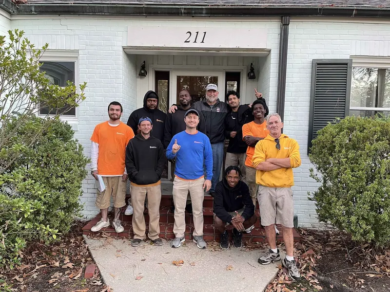 Smart Move team gathered with a family outside their home